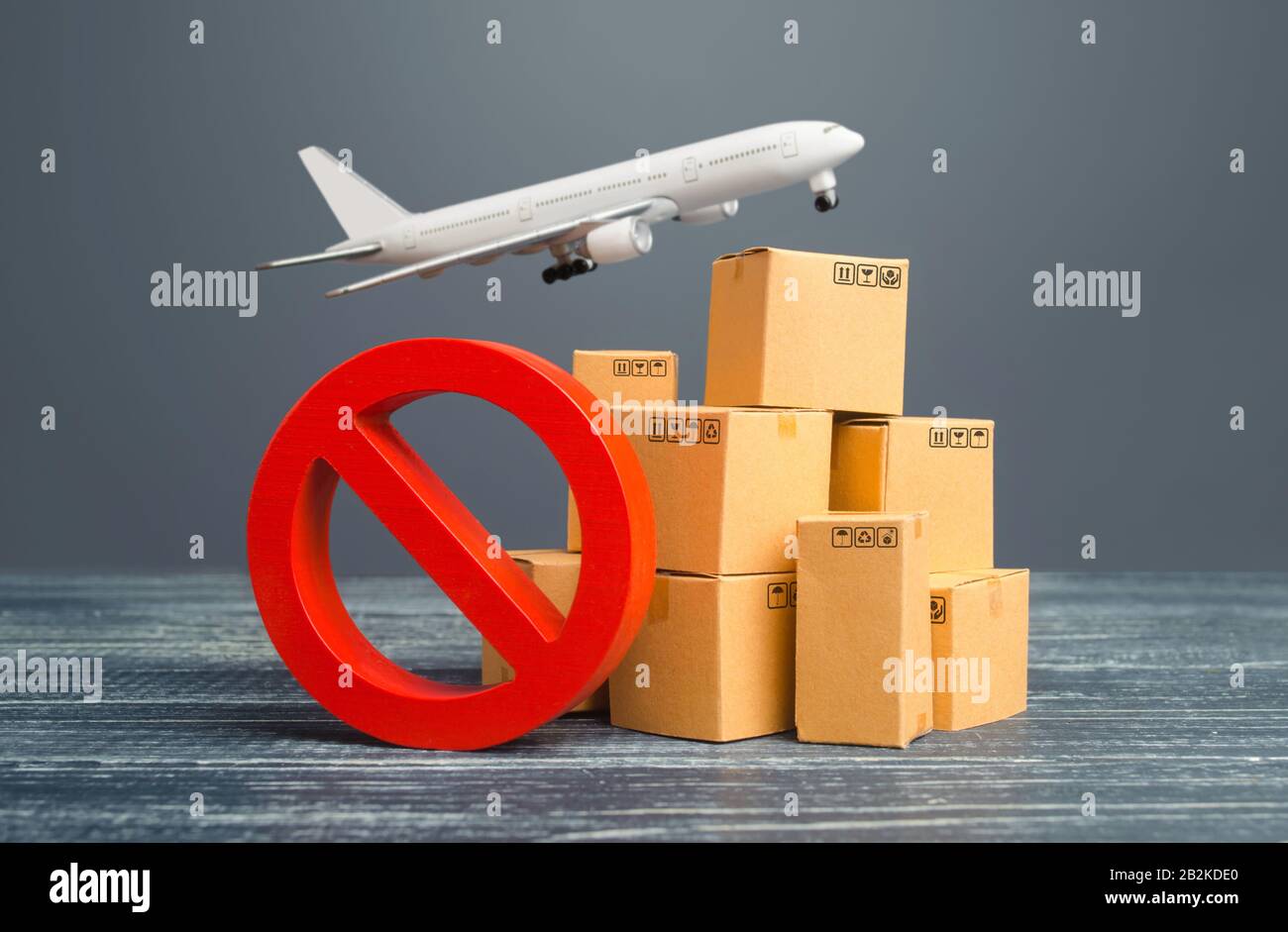 Cardboard boxes and red prohibition symbol NO. Out of stock. Embargo trade wars. Overproduction or scarcity. Restriction on import, ban on export of d Stock Photo