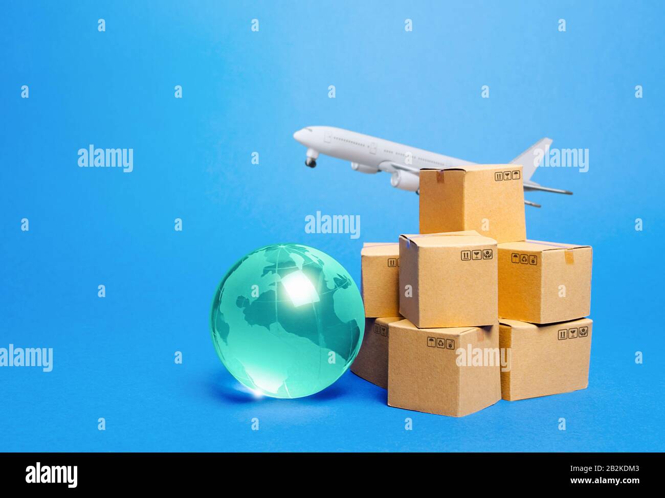 Blue globe, cardboard boxes and freight airplane. International world trade. Deliver goods, shipping. Import export freight traffic. Markets globaliza Stock Photo