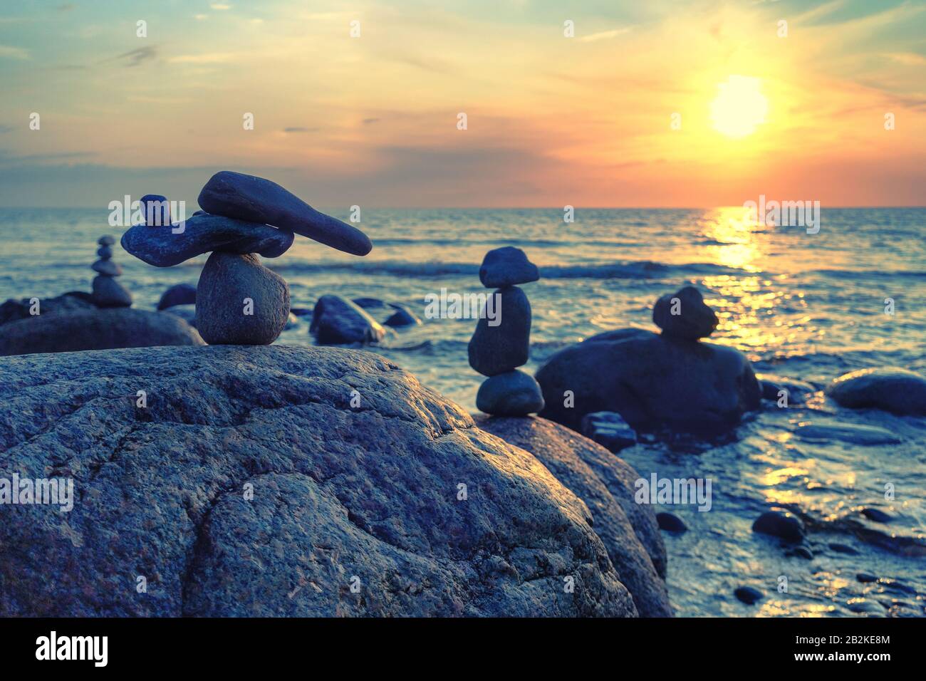 Sea with big stones at sunset Stock Photo