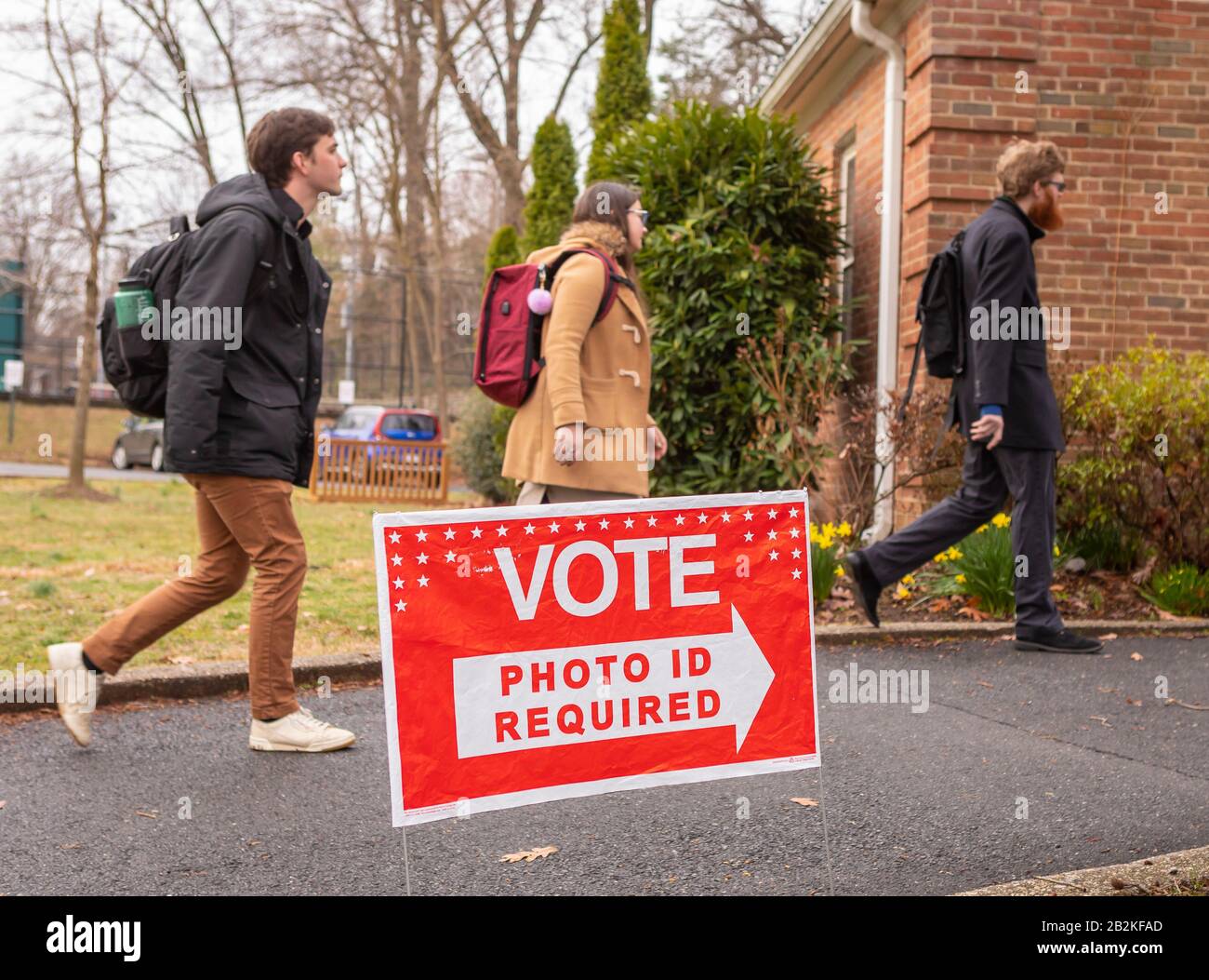 ARLINGTON, VIRGINIA, USA - MARCH 3, 2020: Democratic primary election voters arrive Lyon Village polling place. Photo ID sign. Stock Photo