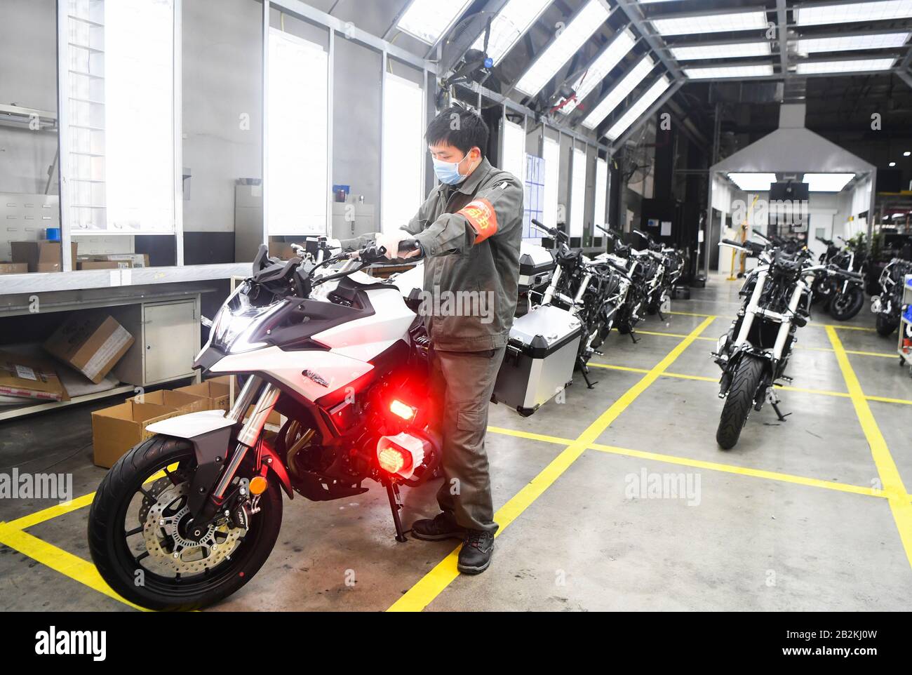 Chongqing, China. 3rd Mar, 2020. A worker tests the motorcycles at the motorcycle production workshop of the Loncin Motor Co., Ltd. in the Chongqing Hi-tech Zone, southwest China, March 3, 2020. The Chongqing Hi-tech Zone has rolled out policies to help companies resume production during the fight against the novel coronavirus. A total of 1,598 companies involving 102,894 workers in the zone have resumed production and operation by the noon of Tuesday. Credit: Wang Quanchao/Xinhua/Alamy Live News Stock Photo