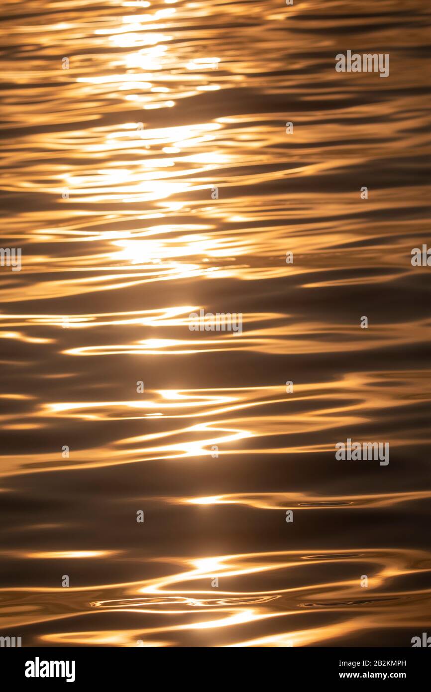 Reflection of the sun in waves Stock Photo