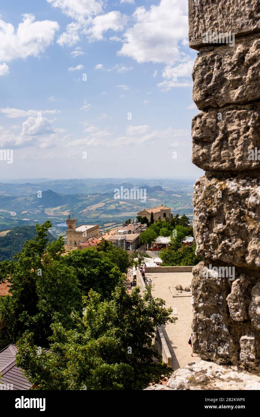 The pastoral North Italian countryside landscape surrounds the mountains and fortified walls of the small Republic of San Marino in Southern Europe Stock Photo