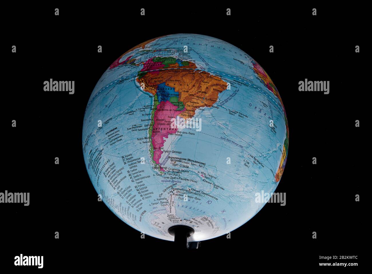 Brazil - March 2020. Globe with Russian geographical names isolated on black bacground Stock Photo