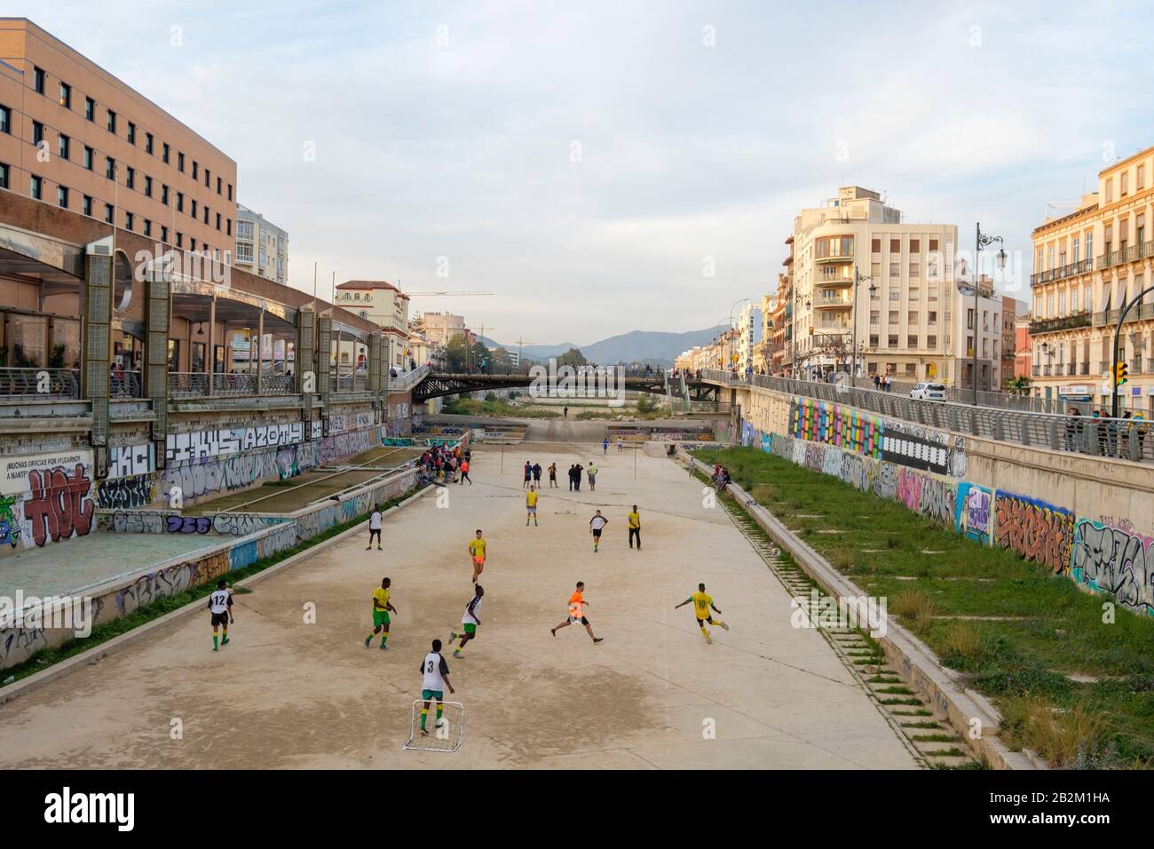People paying football in the dried-up river Rio Guadaimedina. Stock Photo