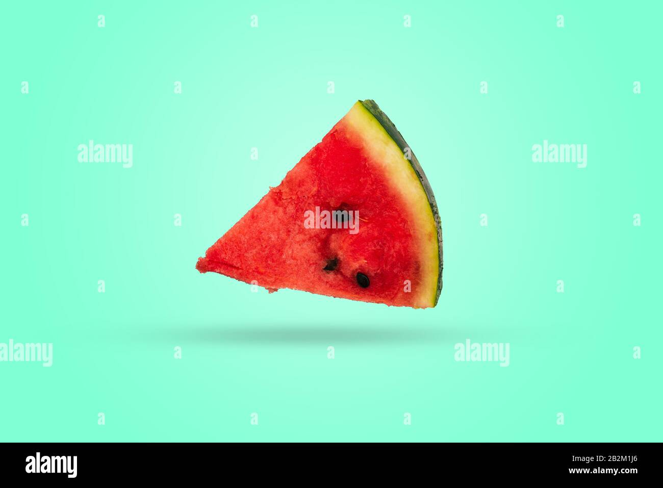 A piece of watermelon triangular in shape on a colored background. Ripe ...
