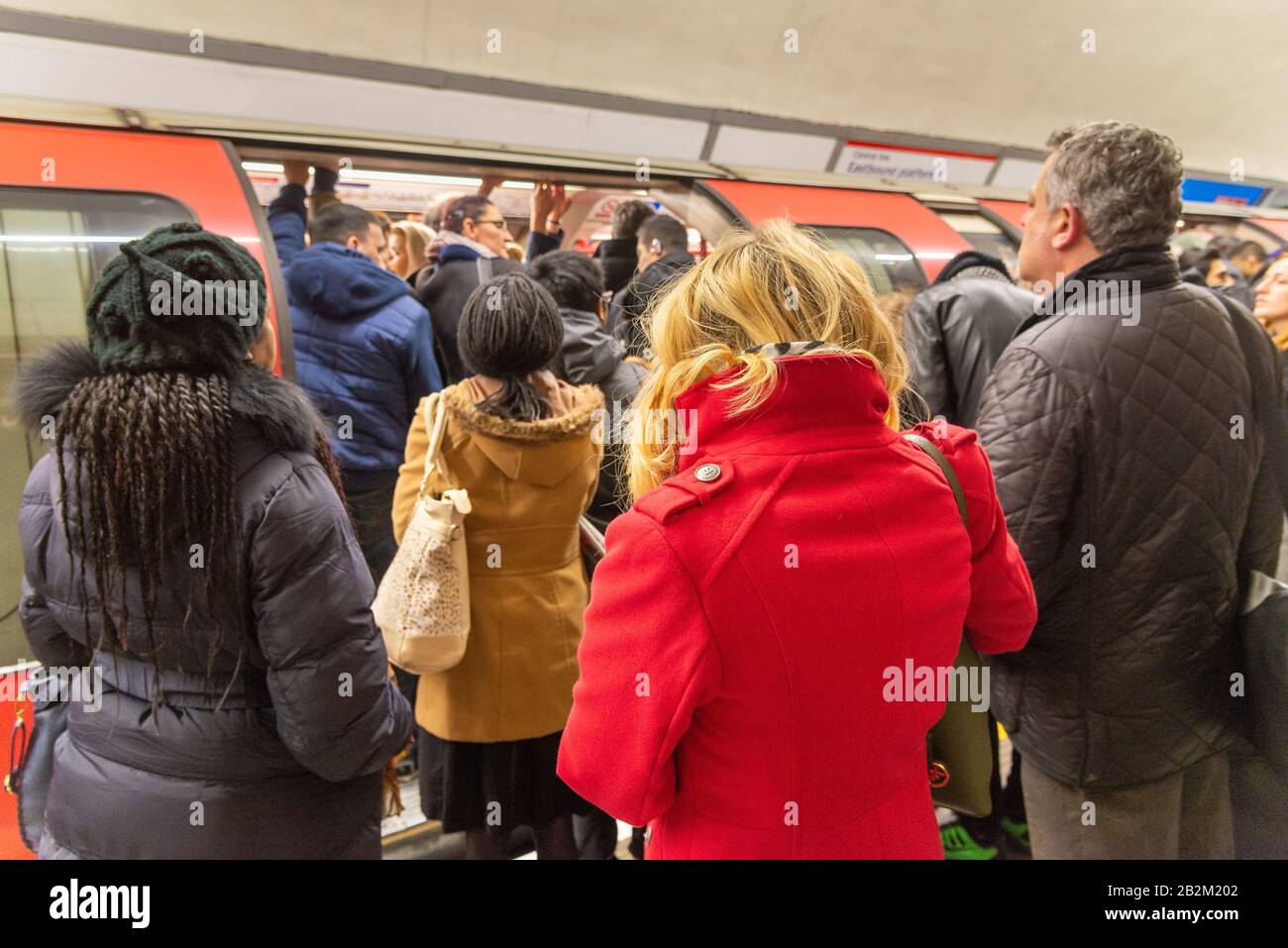 Commuters trying to board overcrowded Central Line London Underground carriage during the morning rush hour, UK Stock Photo