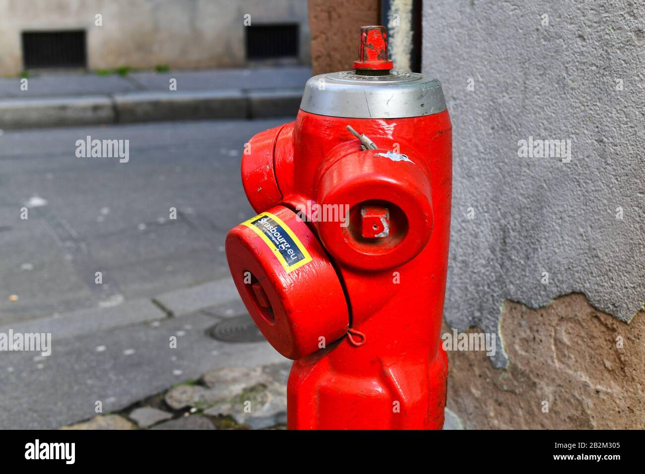 Strasbourg, France - February 2020: Red Fire hydrant with water valves for fire emergencies in street Stock Photo
