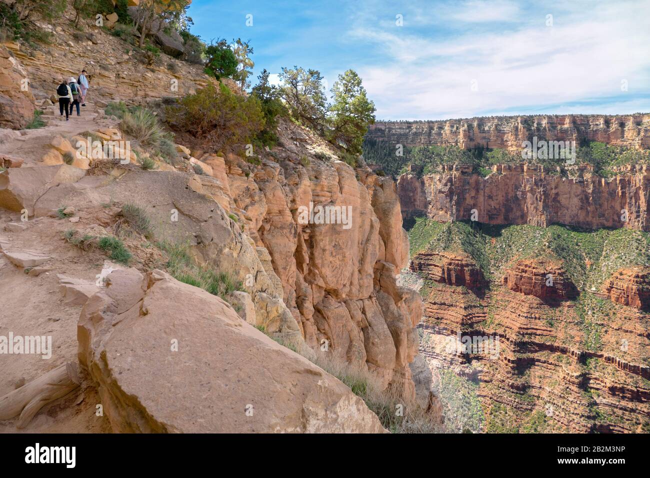 Tourists walk down a cliff path towards the Colorado River in the Grand Canyon National Park 