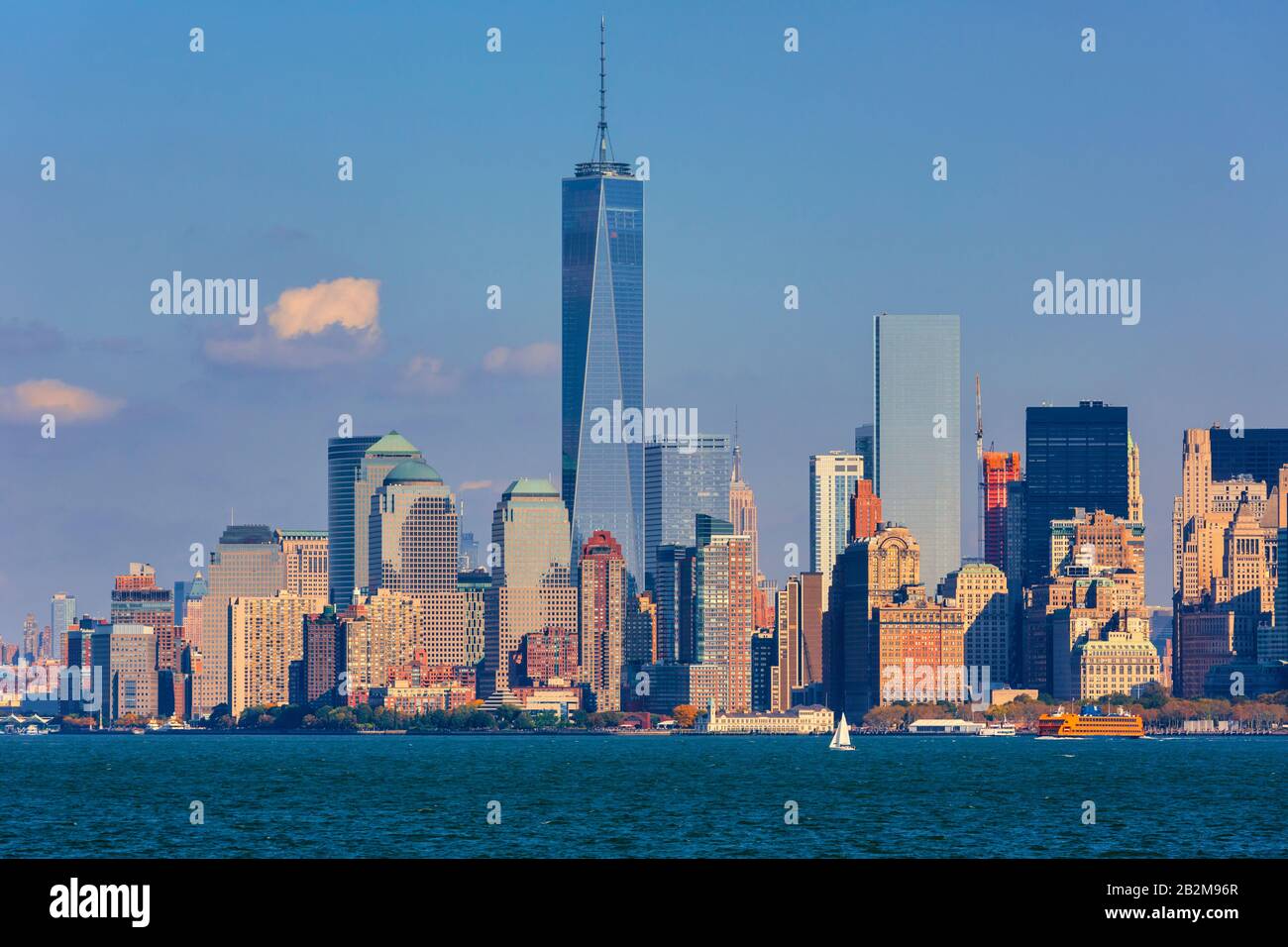 Lower Manhattan seen from New York Bay.  The tall building is One World Trade Center, also known as 1 World Trade Center, 1 WTC or Freedom Tower.  New Stock Photo