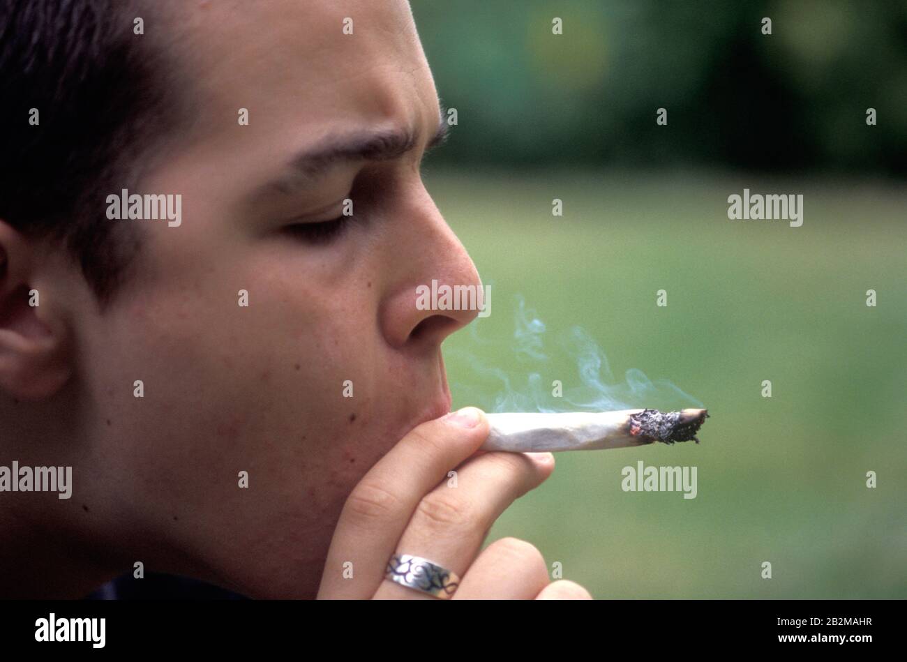 16 year old youth smoking a joint of cannabis; UK. Posed by model Stock Photo