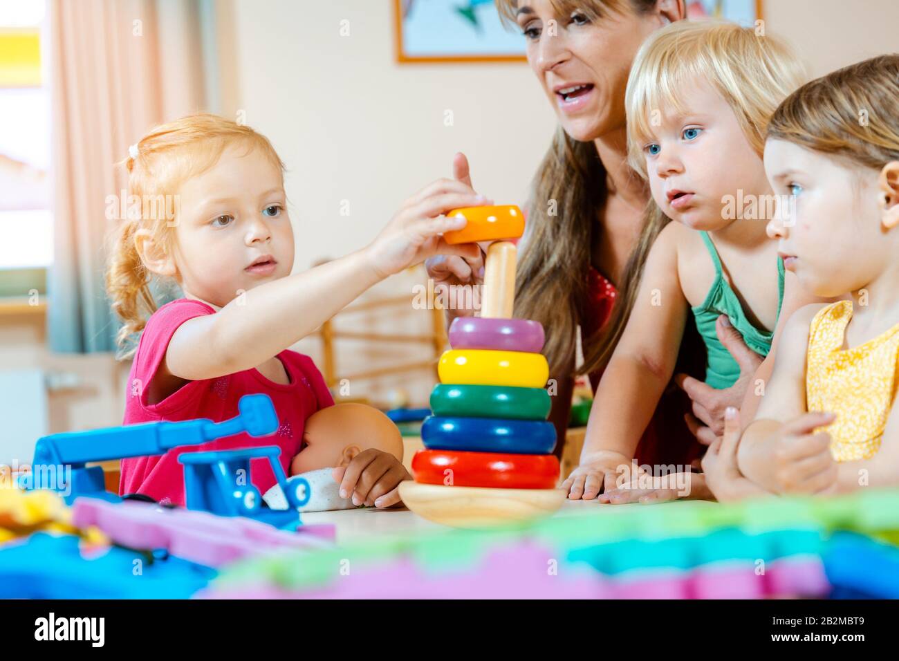 Children in nursery school learning and playing Stock Photo