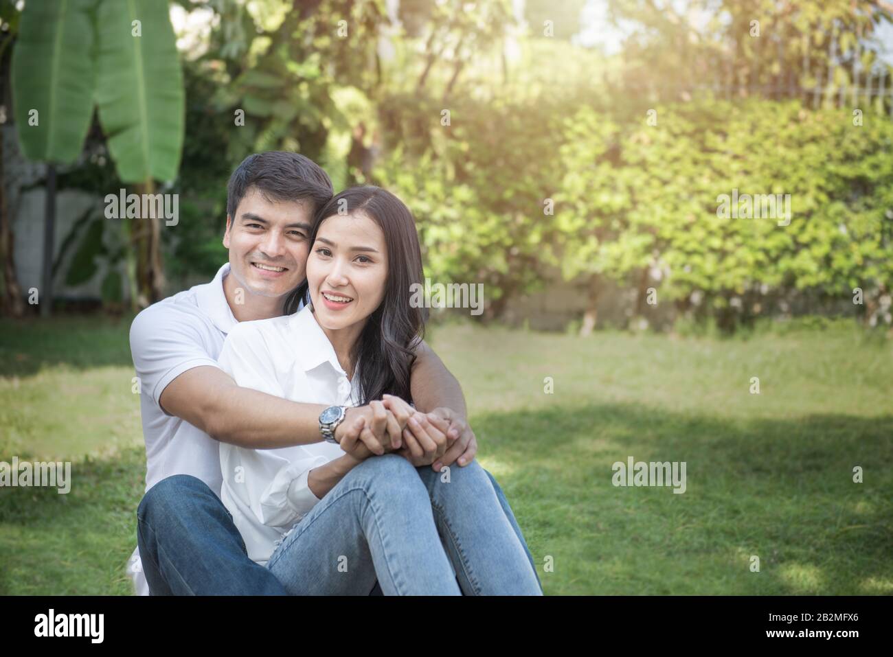 Cute couple have a good time together in front yard,young asian man and ...