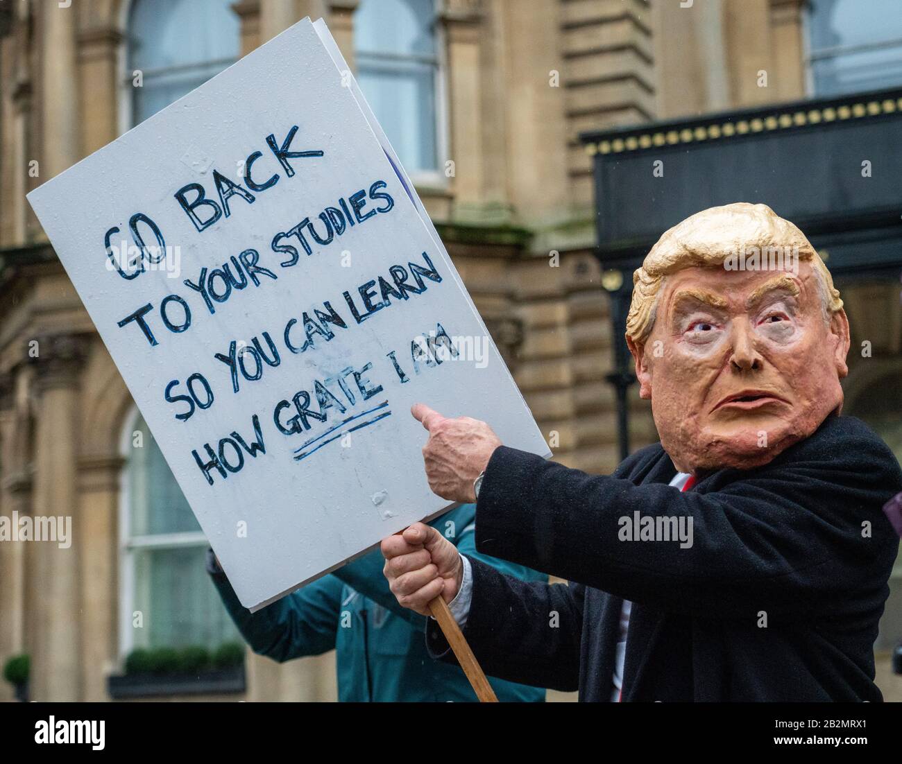 Man in a Donald Trump mask admonishing children for being on school strike on the Greta Thunberg March for Climate in Bristol UK Stock Photo