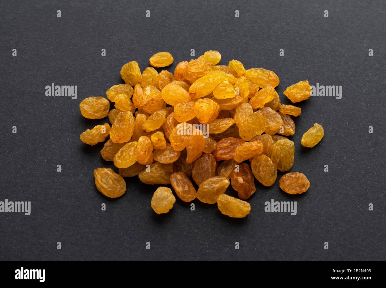 Dried yellow raisins on black background Stock Photo