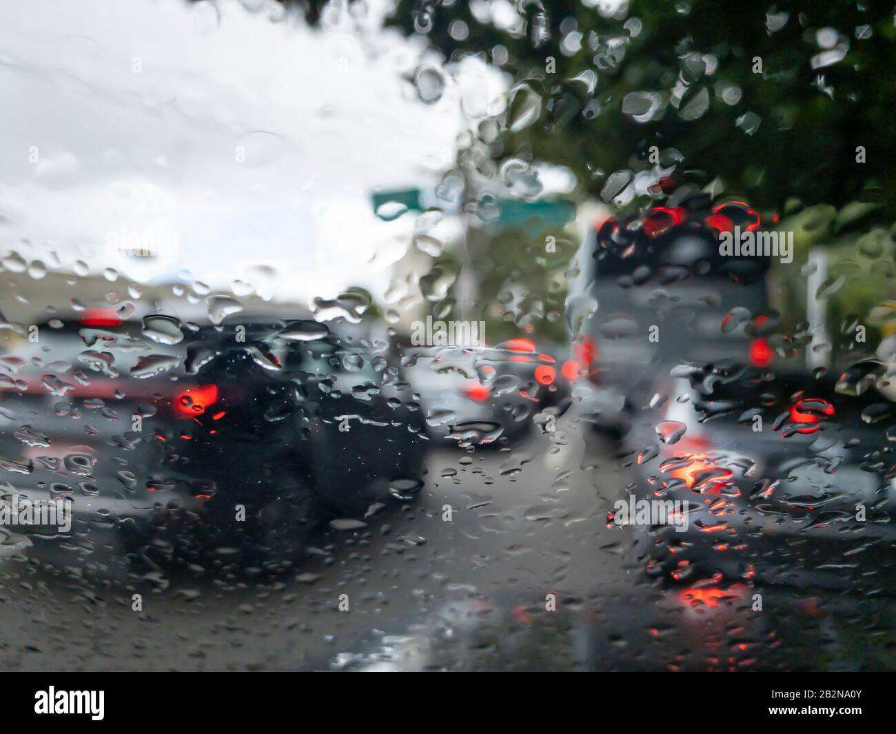 rain droplets on car windshield, traffic in city Stock Photo - Alamy