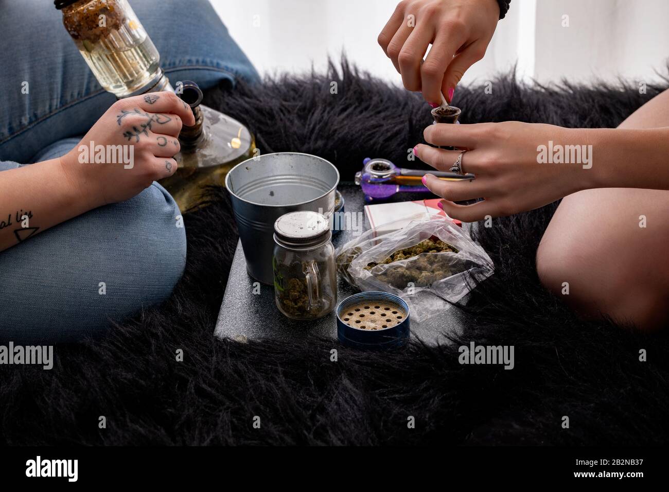 Two People Using Recreational Cannabis with User Paraphernalia Stock Photo