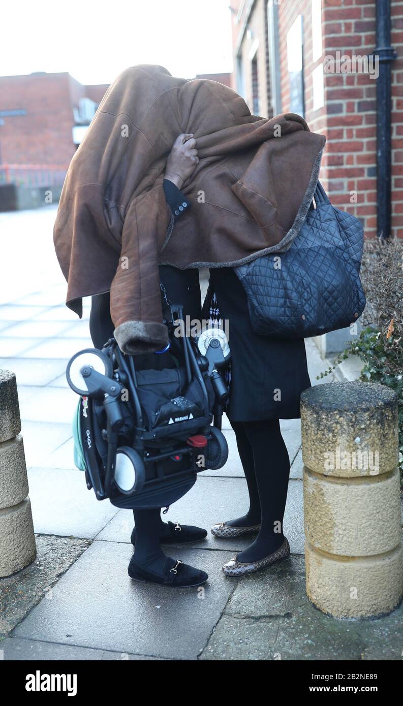 Mary Roberts, 53, (left) and her daughter Henrietta Mitaiare, 23, cover their heads as they leave Uxbridge Magistrates' Court, in Middlesex where they appeared charged with failing to obey the lawful commands of Captain Guido Keel and assault by beating on board an aircraft at Heathrow. PA Photo. Picture date: Tuesday March 3, 2020. The mother and daughter assaulted an airline captain in his cockpit after they were not allowed to store a baby carrier in the cabin, a court has heard. Mitaiare and her mother, allegedly pushed Captain Guido Keel to the floor, then scratched and kicked him after t Stock Photo