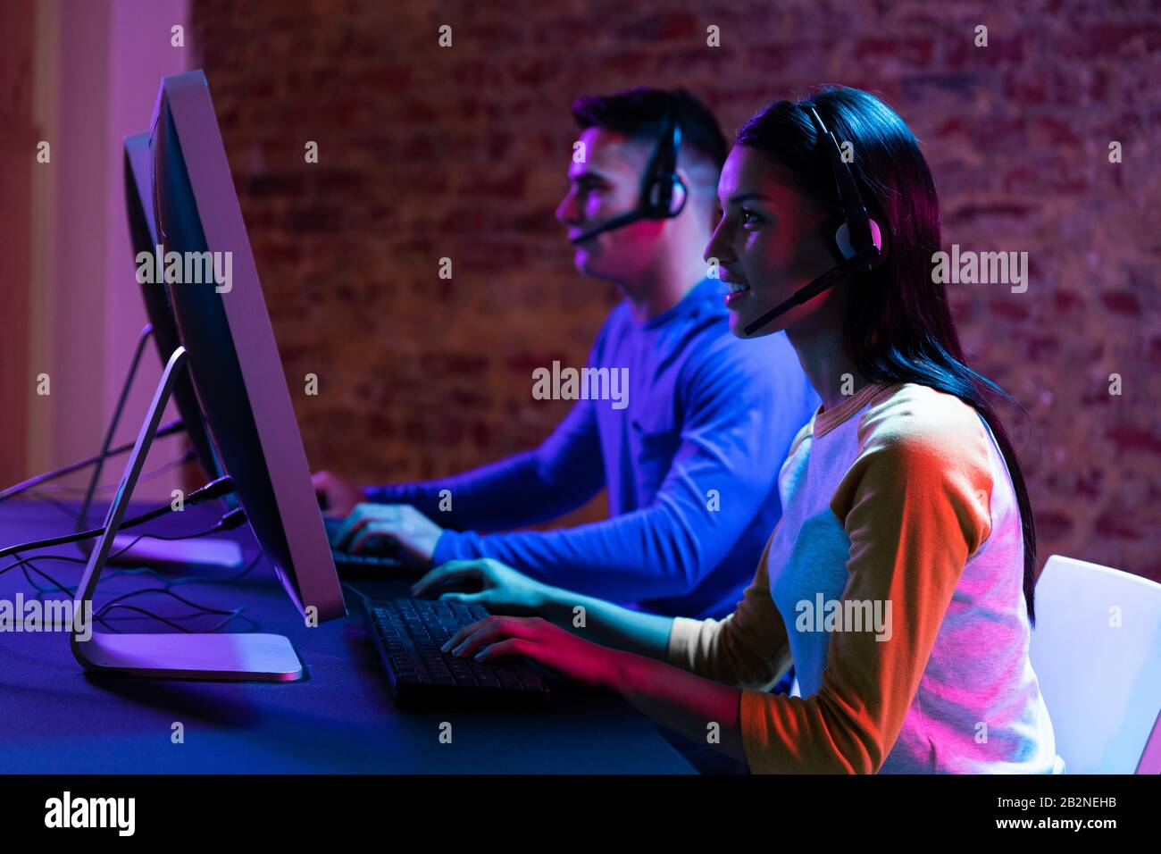 Caucasian man and a mixed race woman working late in a customer support office Stock Photo