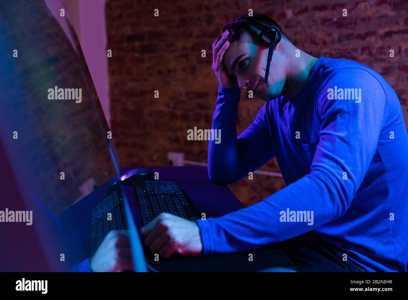 Caucasian man working late in a customer support office Stock Photo