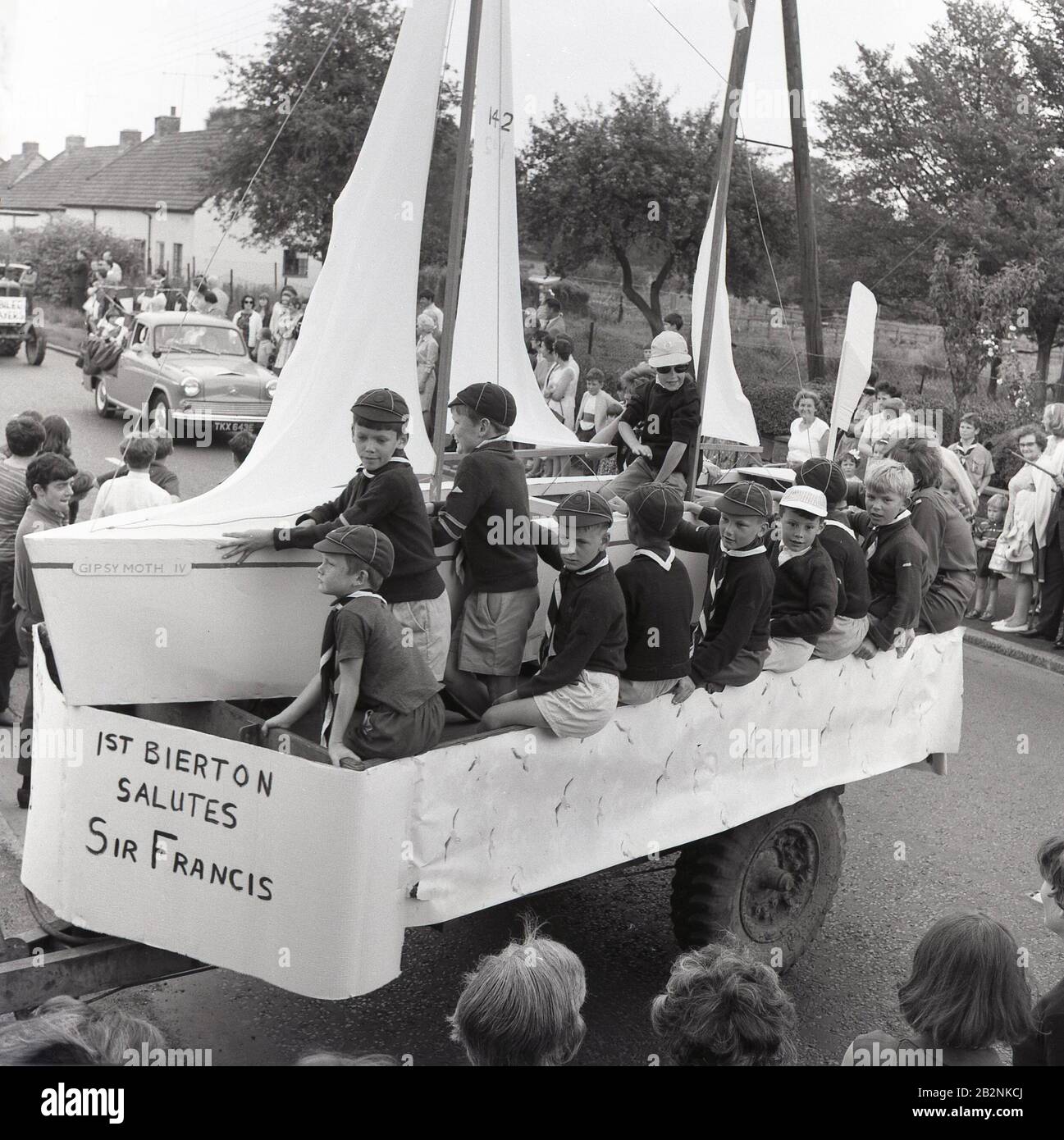 1960s, historical, Cub scouts on a float in a carnival dressed as the boat, 'Gipsy Moth IV', to celebrate the achievements of 'Round-the-World' sailor Sir Francis Chichester, Bierton, Buckinghamshire, England, UK. Chichester became the first person to sail single-handed around the world by the clipper route in nined month and one day in 1966-67. Stock Photo