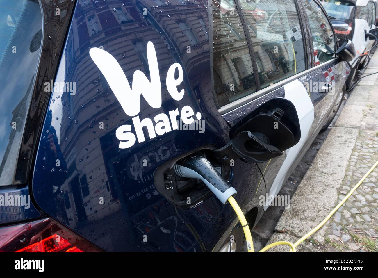 Electric car o fWe Share car sharing company  charging on street in Prenzlauer Berg, Berlin, Germany Stock Photo