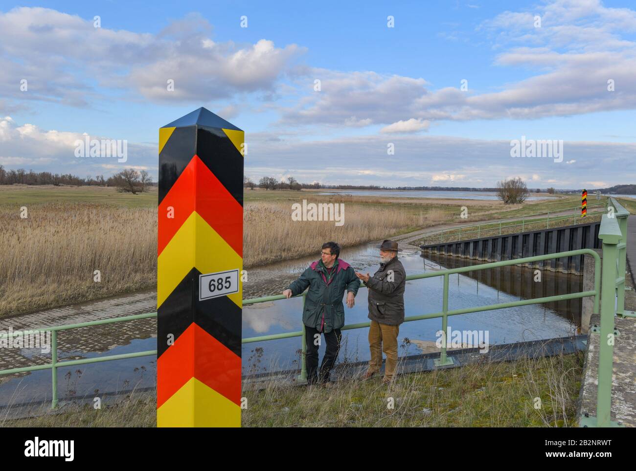 Criewen, Germany. 27th Feb, 2020. Dirk Treichel (l), head of the Lower Oder Valley National Park and Michael Tautenhahn, hydrologist in the National Park administration, stand at an open weir through which no water flows. The past dry years have severely affected the Lower Oder Valley National Park and are changing both flora and fauna. Credit: Patrick Pleul/dpa-Zentralbild/ZB/dpa/Alamy Live News Stock Photo