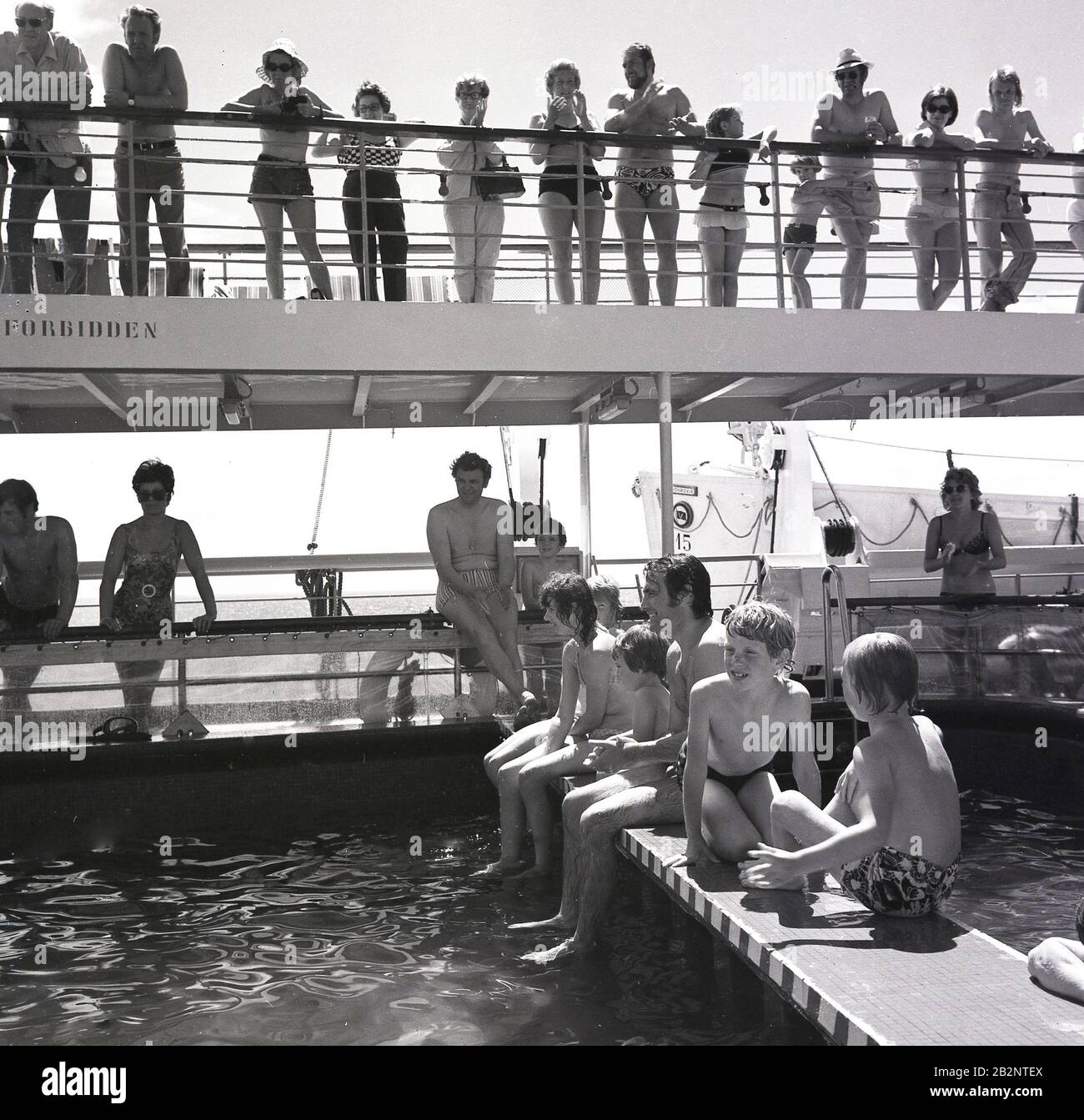 1960s, historical, passengers sitting outside by the swimming pool on board a cruise ship of the era. Stock Photo