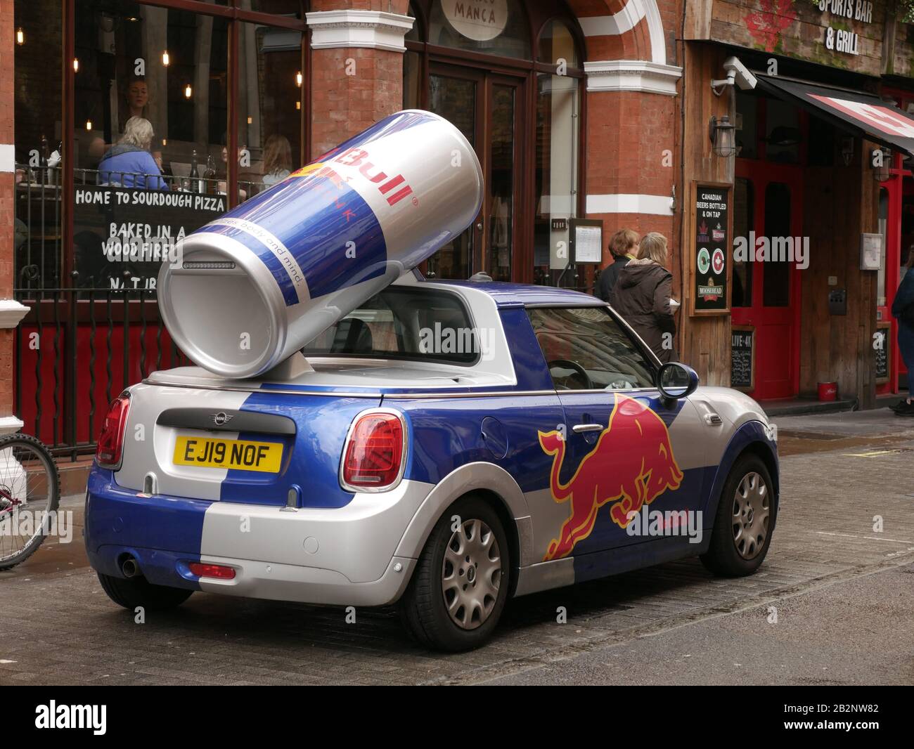 Mini Cooper advertising Red Bull energy drink parked in Maiden Lane, Covent Garden, London, UK Stock Photo