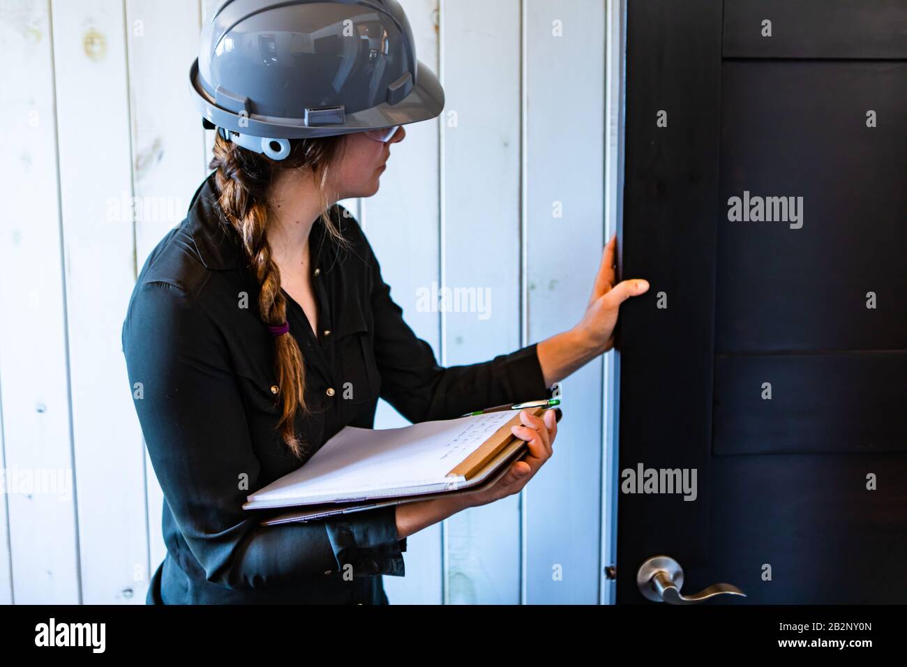 worker woman wears a grey hard hat at work. female construction
