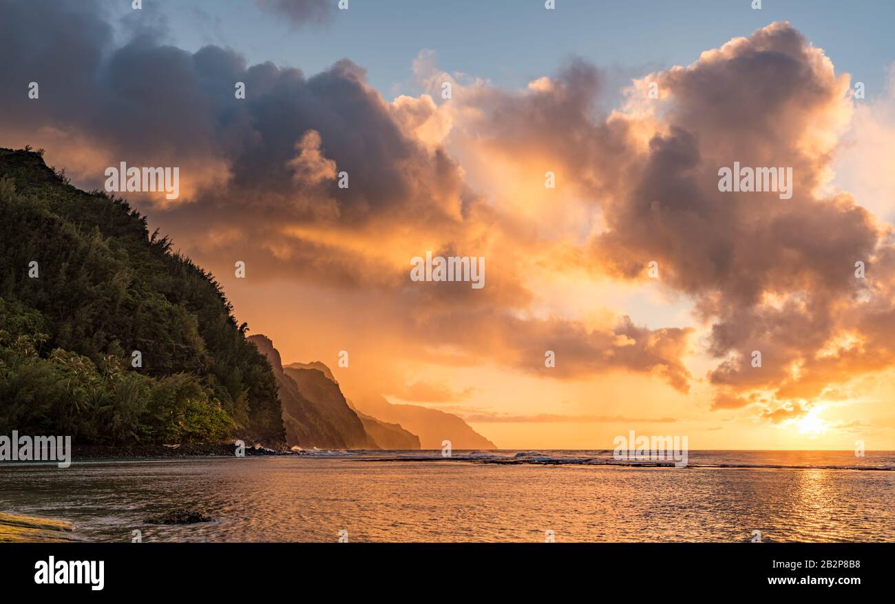 Sunset lights the receding cliffs of the NaPali coastline on north coast of Kauai in Hawaii Stock Photo