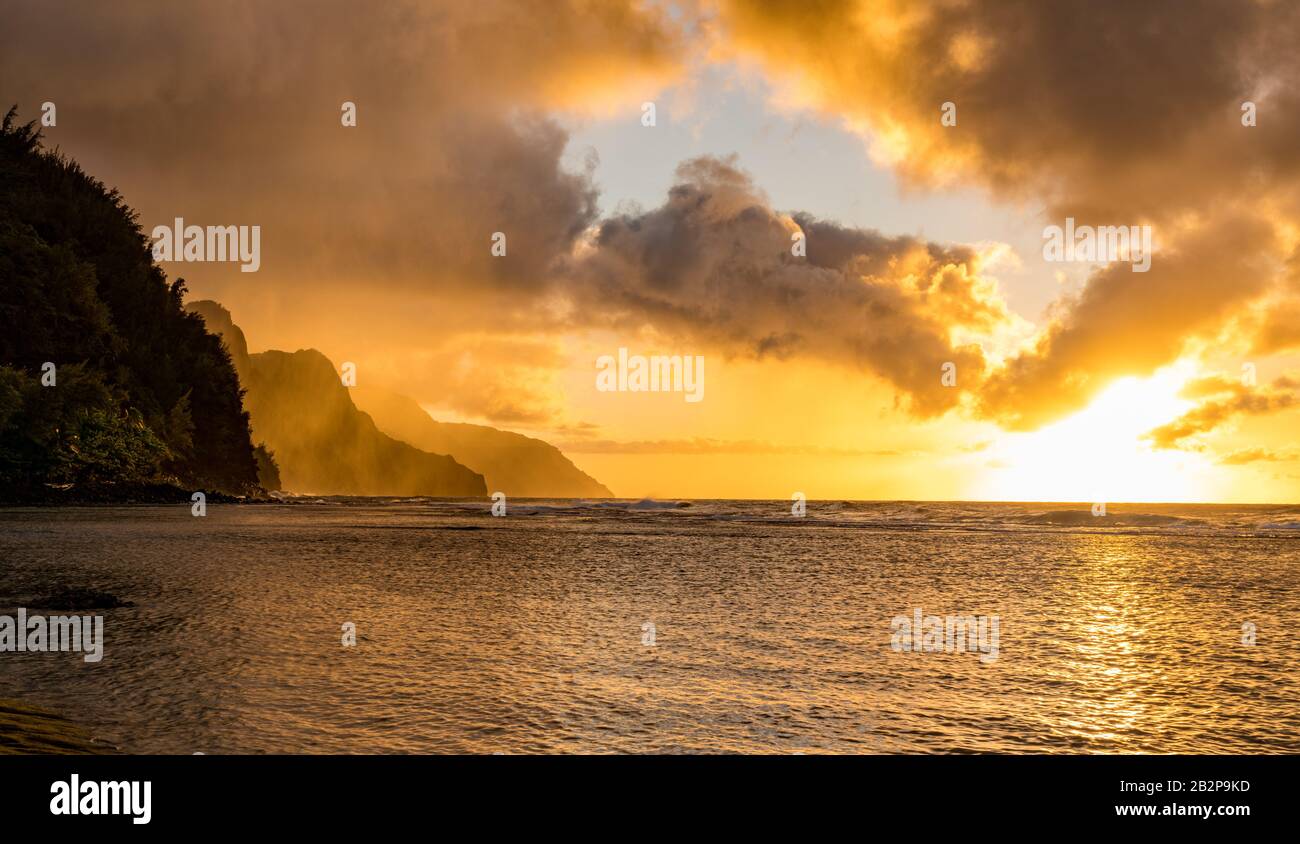 Sunset lights the receding cliffs of the NaPali coastline on north coast of Kauai in Hawaii Stock Photo