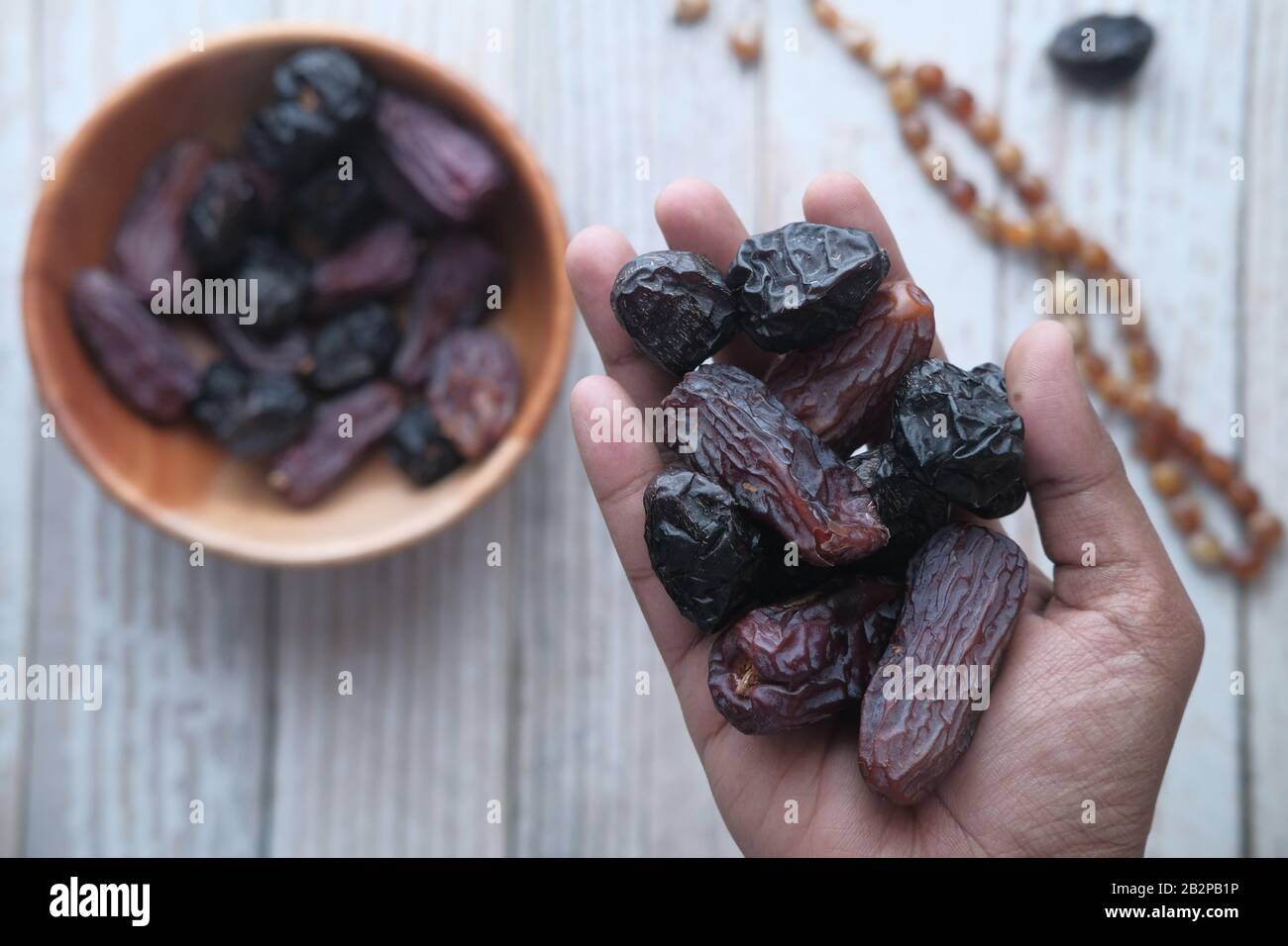 top view of fresh date fruit on hand, ramadan concept  Stock Photo