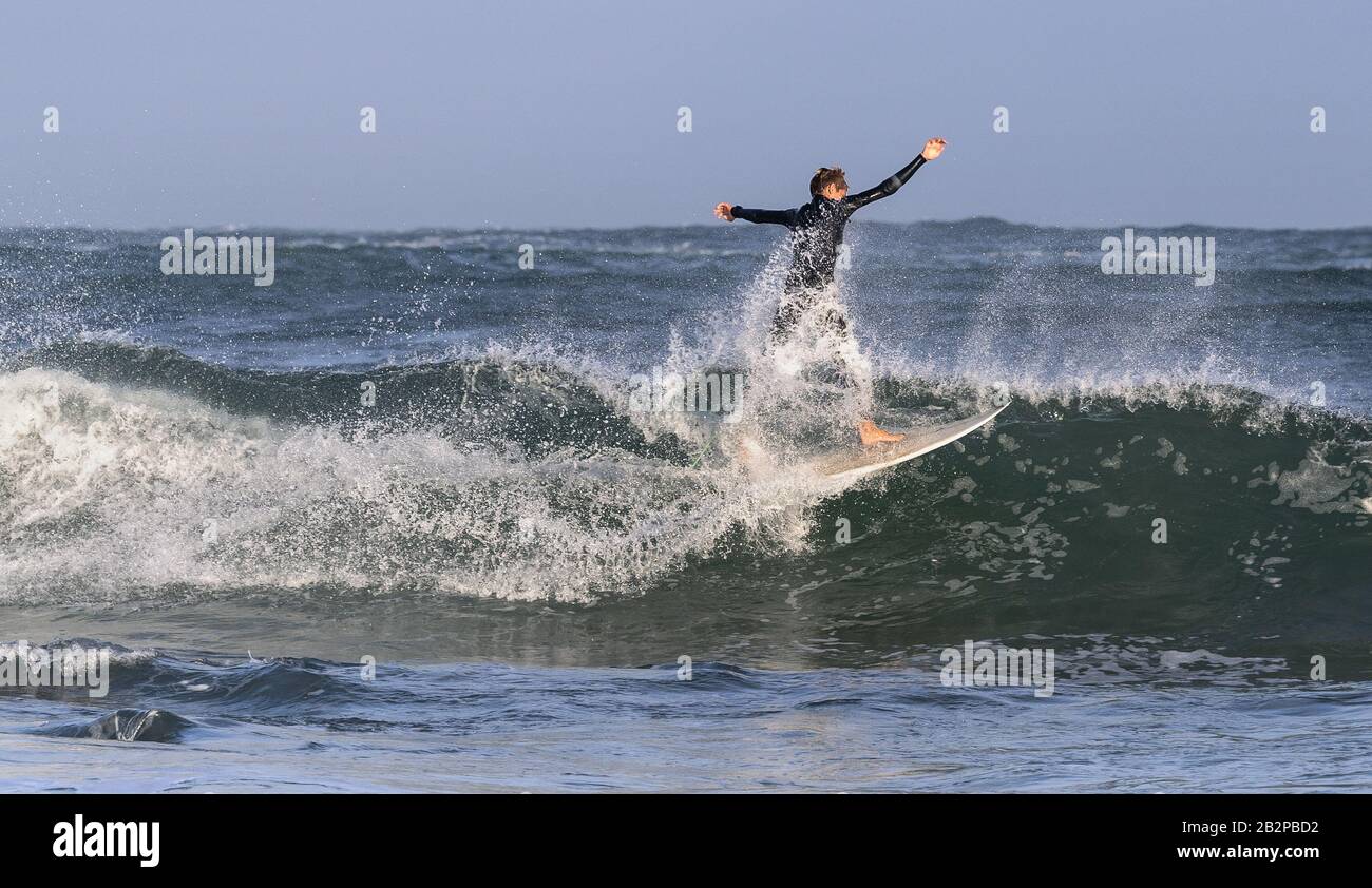 Mossel Bay, South Africa. Surfing the waves. Surfer riding wave,  storm sky Stock Photo