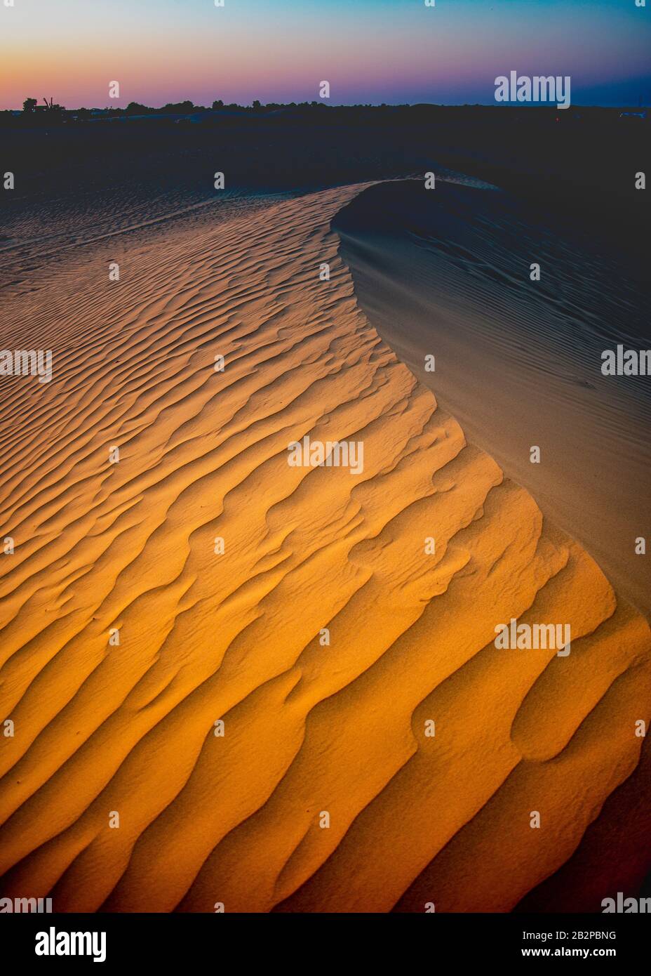 sunset in the desert,large sand dune,in foreground. view from the love lake, Dubai. Stock Photo