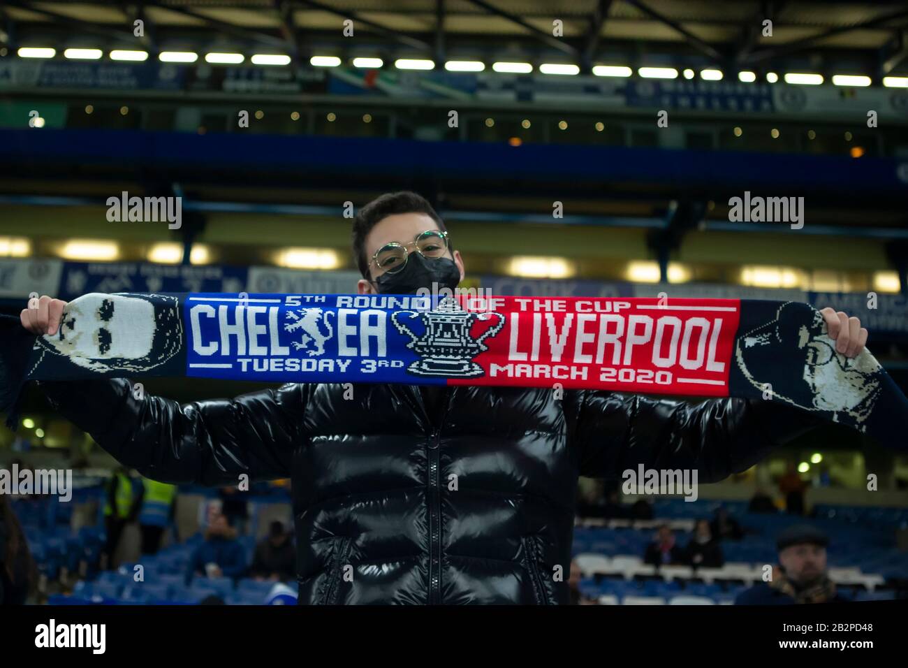 Stamford Bridge, London, UK. 3rd Mar, 2020. English FA Cup Football, Chelsea versus Liverpool; A Chelsea fan wears a face mask due to the Corona virus scare while holding up a half and half scarf Credit: Action Plus Sports/Alamy Live News Stock Photo