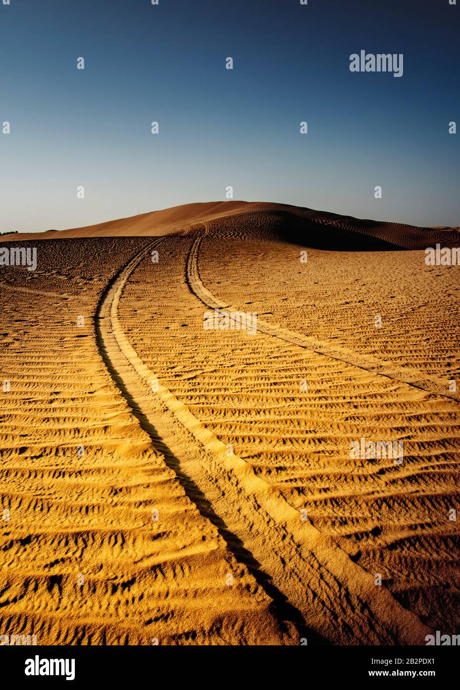 color image taken at dusk, abstract view of Tyre tracks through,the desert, Stock Photo