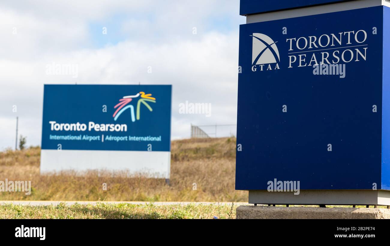 GTAA (Greater Toronto Airport Authority) Toronto Pearson sign with Toronto Pearson International Airport sign in the background. Stock Photo