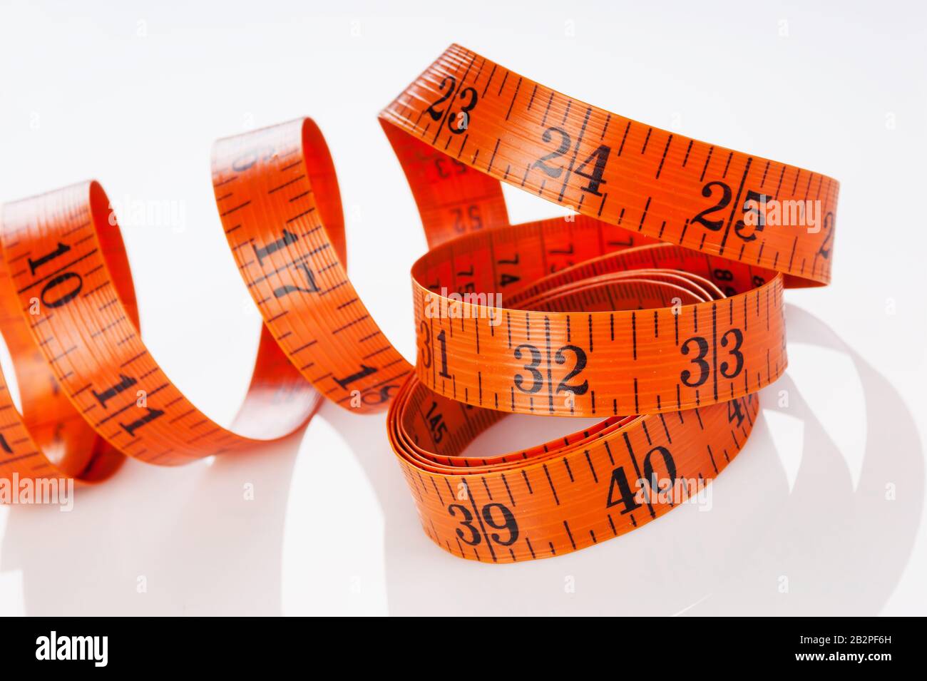 Measuring tape of the tailor on white background Stock Photo - Alamy