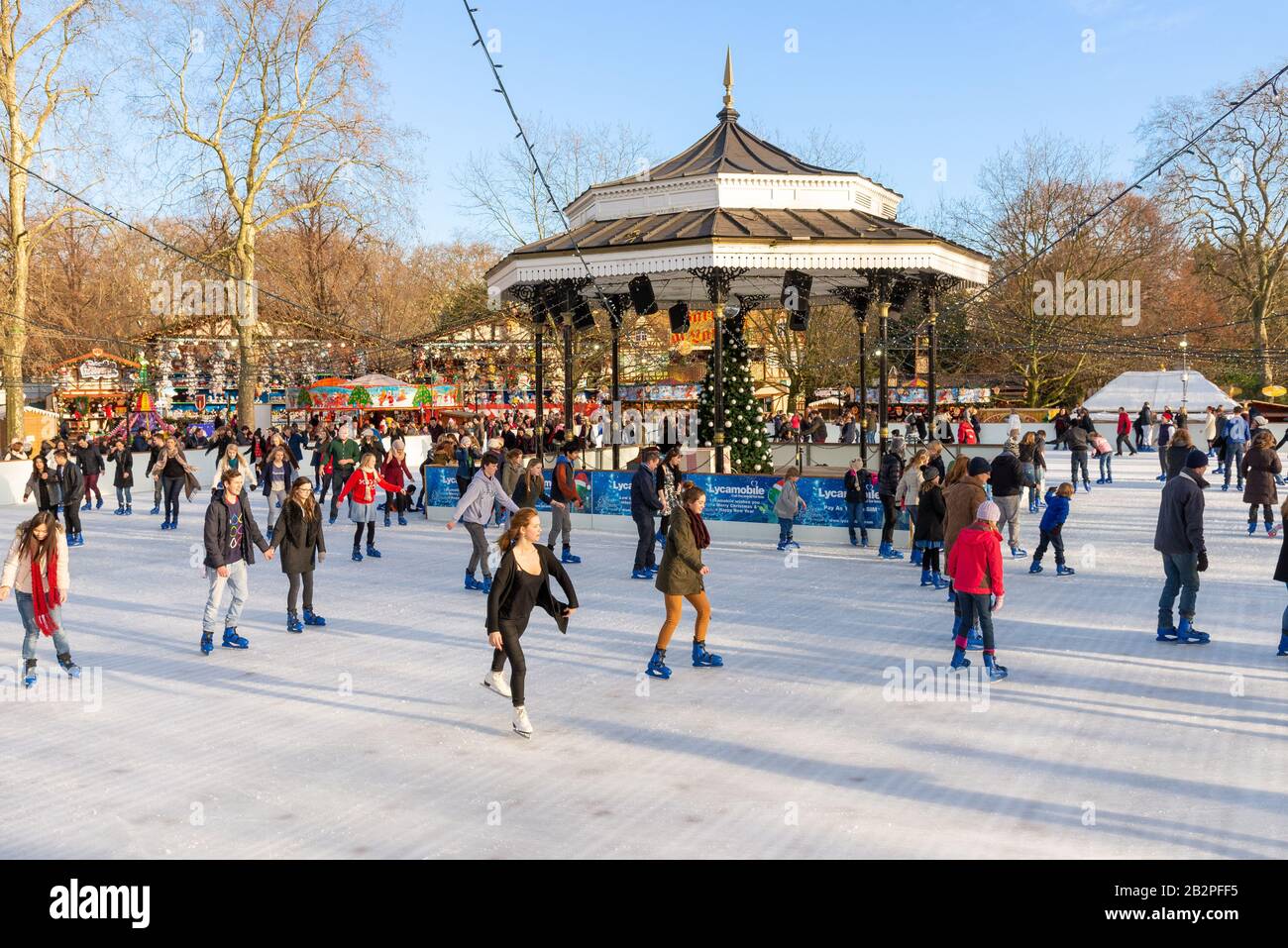 Open air ice skating rink at Christmas at Winter Wonderland, Hyde Park, London, UK Stock Photo