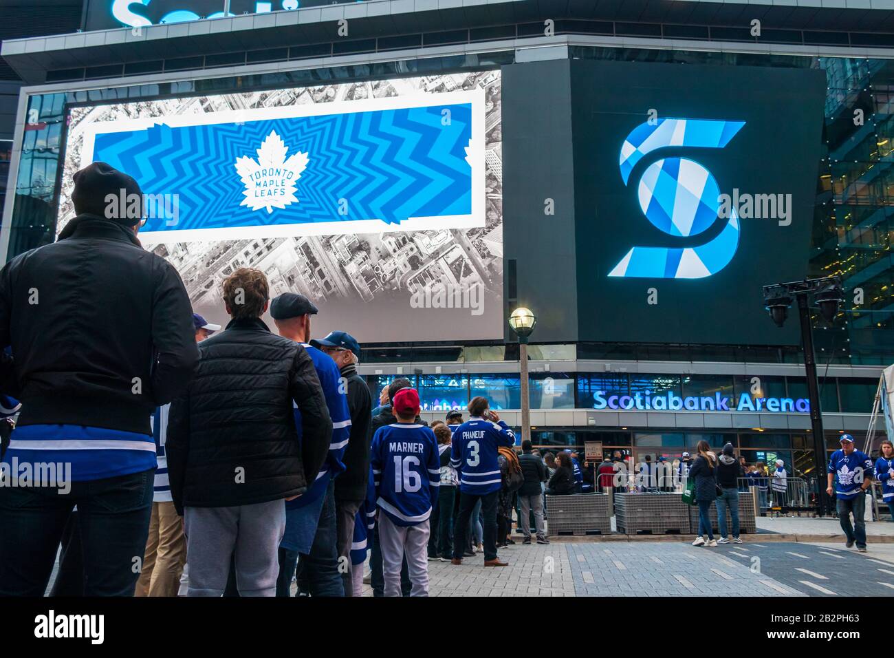 Inside Maple Leafs Square in-front of Scotiabank Arena on game day for the Toronto Maple Leafs as fans wait in line to enter the arena. Stock Photo