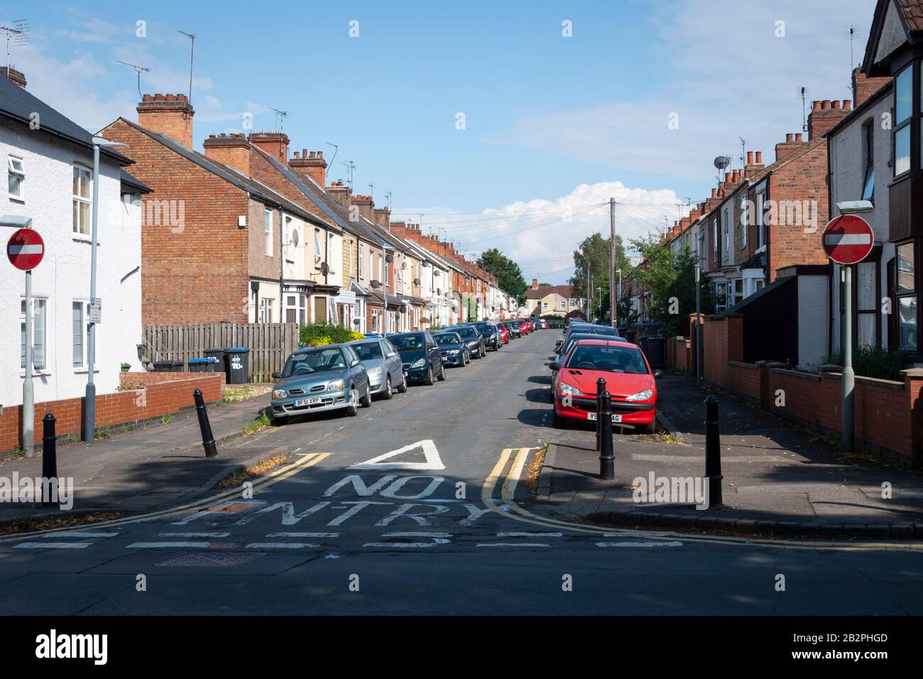 Narrow street with terraced houses, Rugby, Warwickshire, England Stock Photo