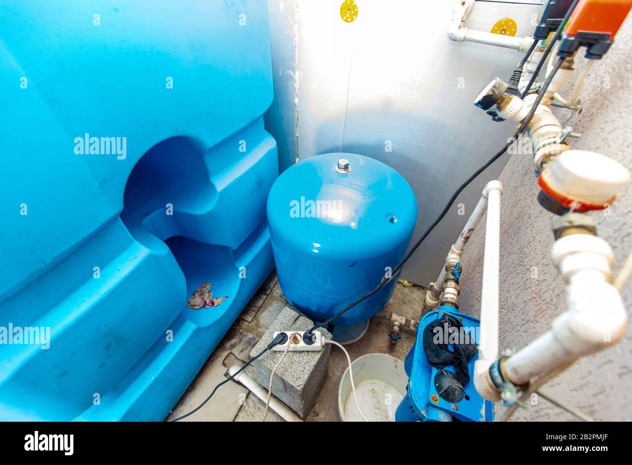 water tanks and pumps for water supply in the basement of the cottage