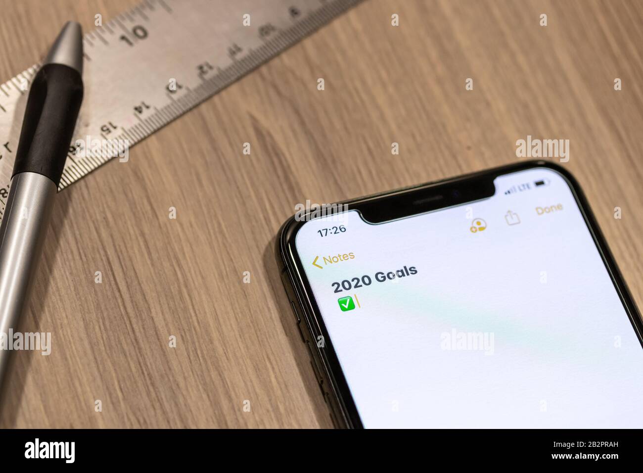 Smartphone notepad titled “2020 Goals” while placed on a desk. Stock Photo