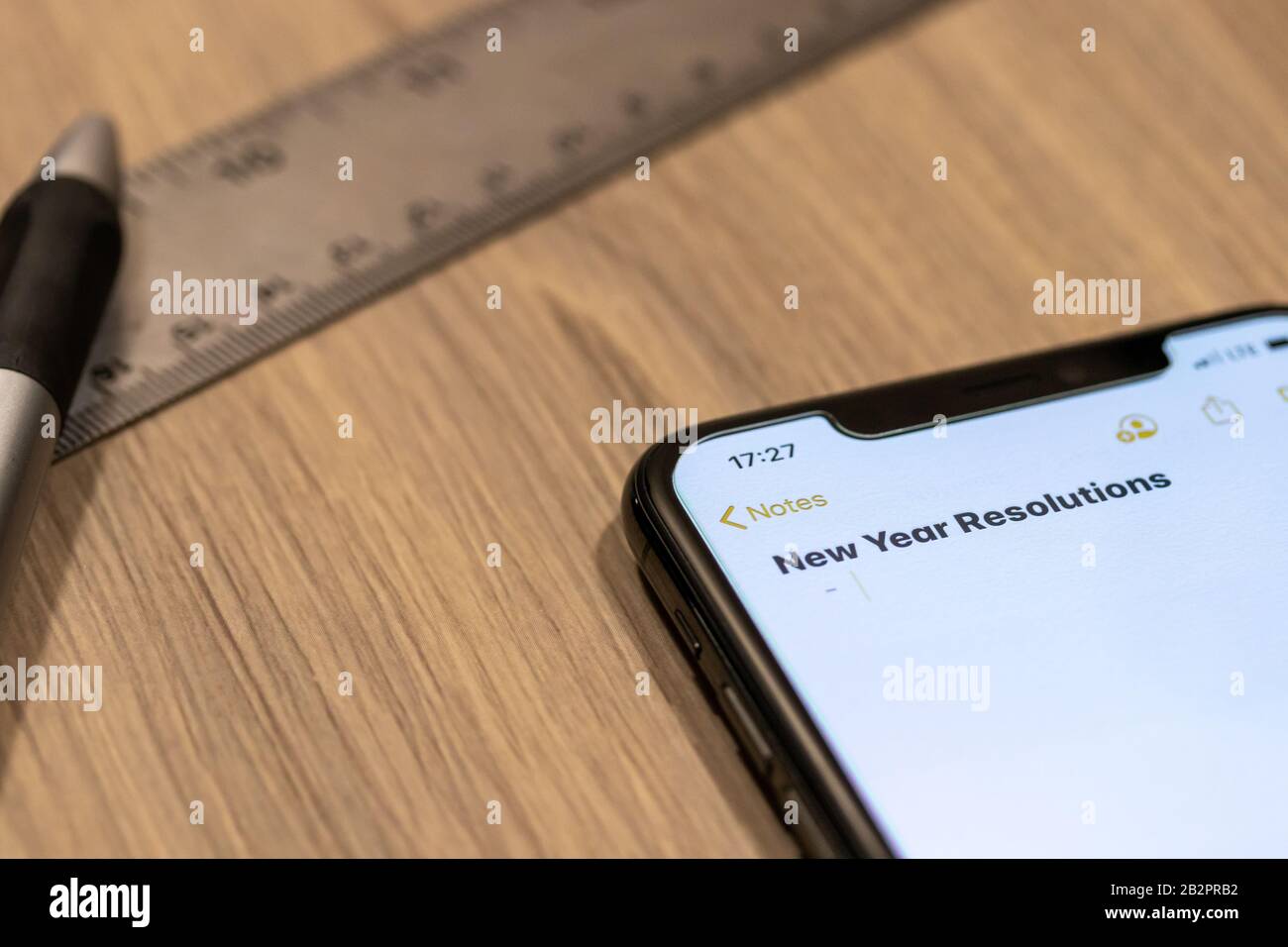 Smartphone notepad titled “2020 Goals” while placed on a desk. Stock Photo
