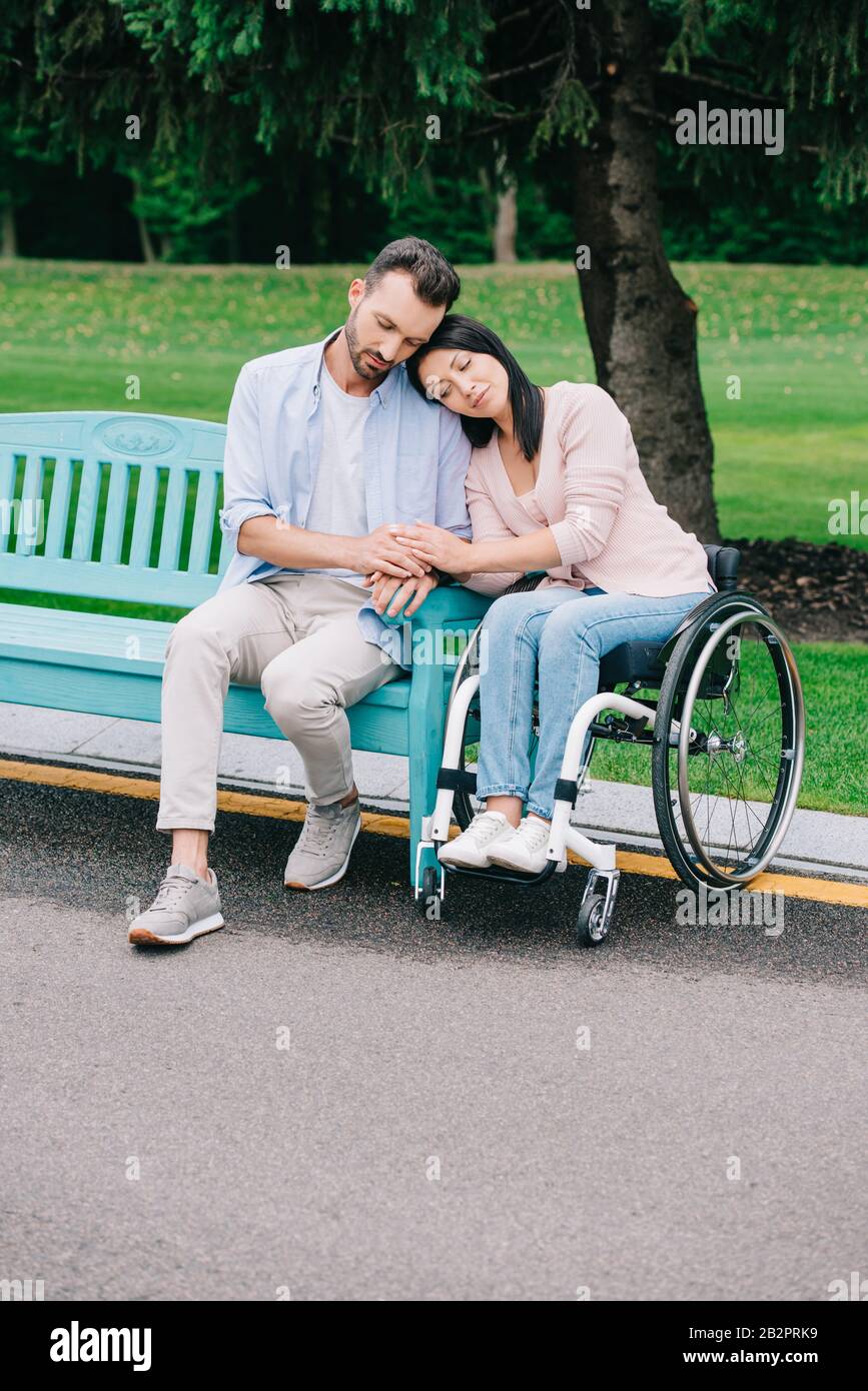 pretty disabled woman with handsome boyfriend resting in park together Stock Photo Alamy