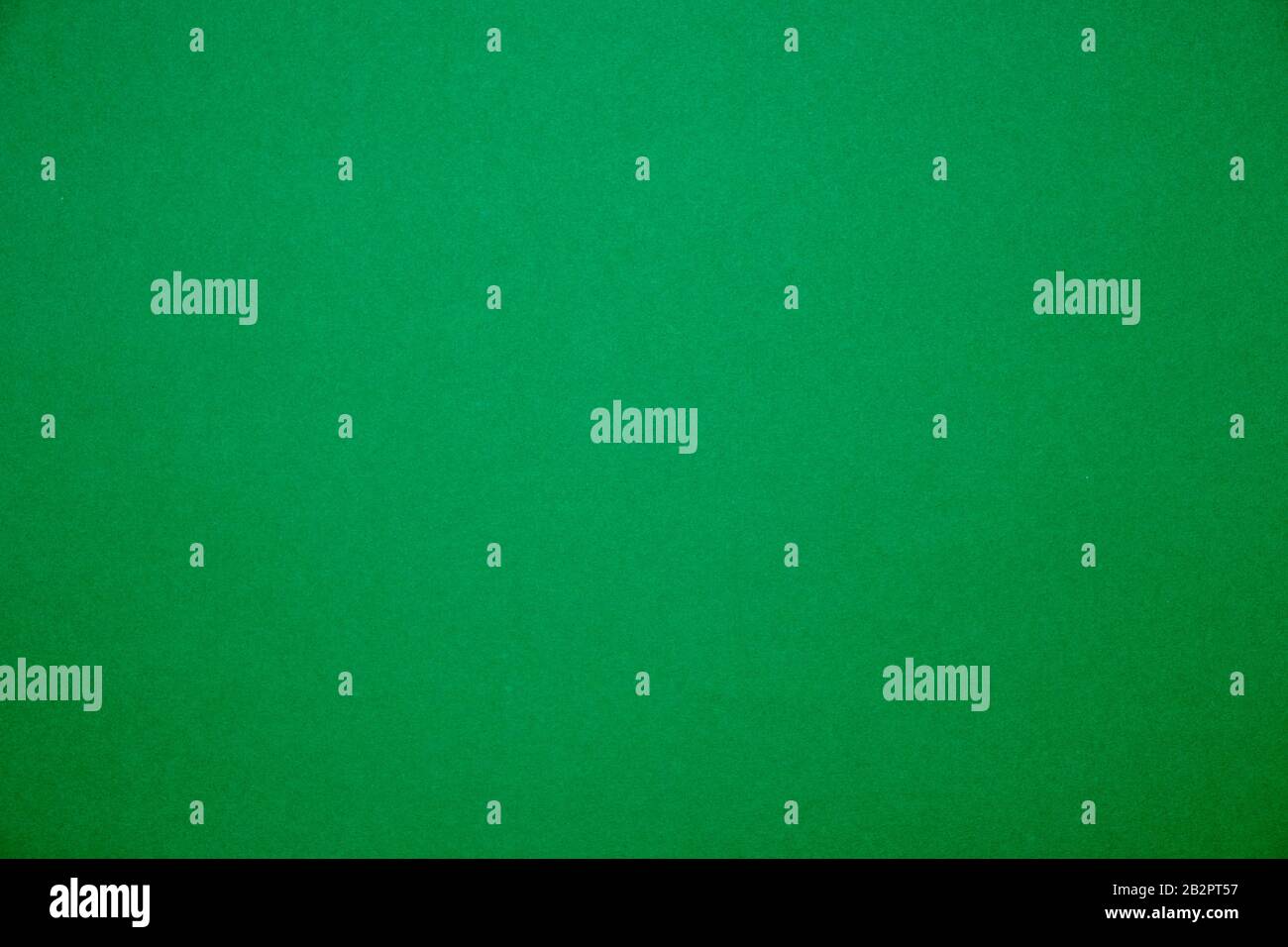 Bright green background.Red cardboard texture Stock Photo