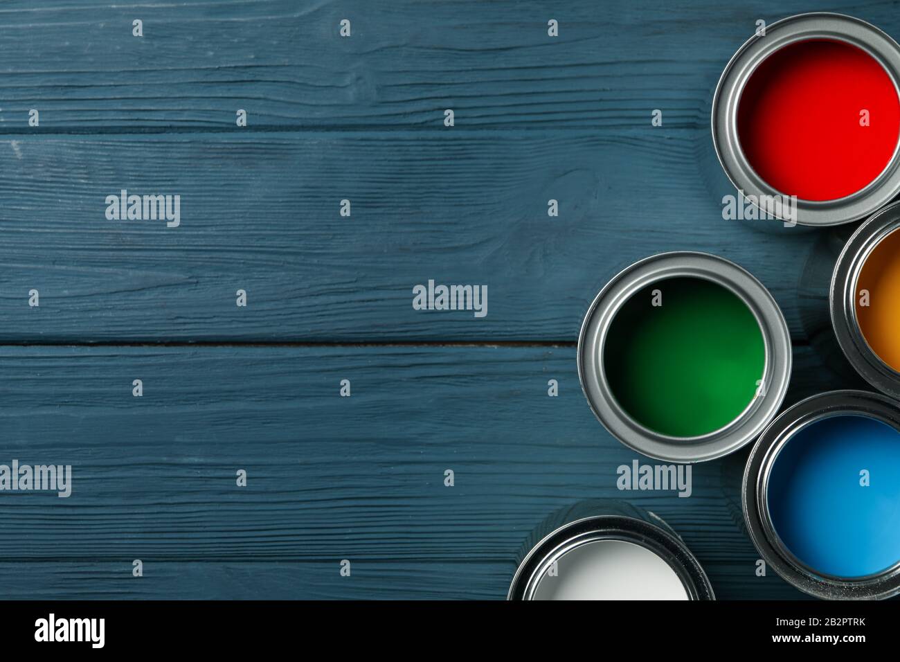 Paint cans on wooden background, space for text Stock Photo