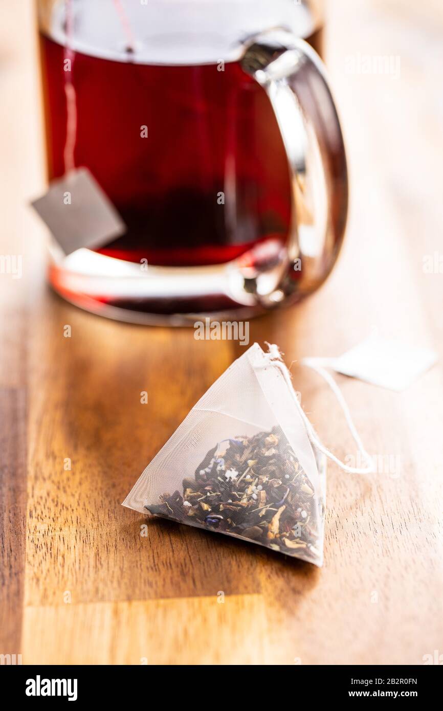 Floral tea bag on wooden table. Stock Photo