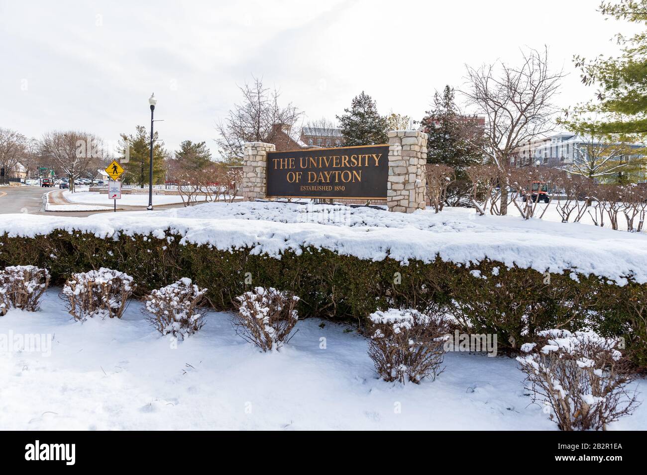 Dayton, OH, USA / February 28, 2020: University of Dayton sign, with fresh winter snow on the ground. Stock Photo